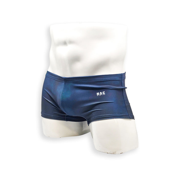 Men’s navy plumbing graphic swim trunk – Box Cut angled front view in rich navy with relaxed short trunk shape