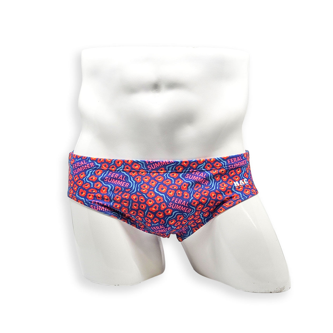 Front view of HAC Swim Basic Swim Brief in the Feral Summer print featuring electric blue, hot pink lettering and orange abstract pattern.