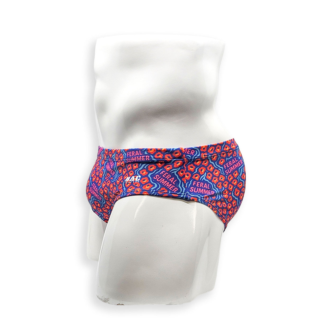 Side view of male model wearing HAC Swim Feral Summer Basic Swim Brief with sporty fit and bold blue, pink and orange graphic print.