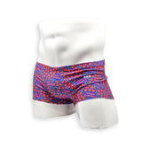 Hero view of HAC Swim Box Cut swim trunk in the Feral Summer print featuring electric blue, hot pink lettering and orange abstract pattern.