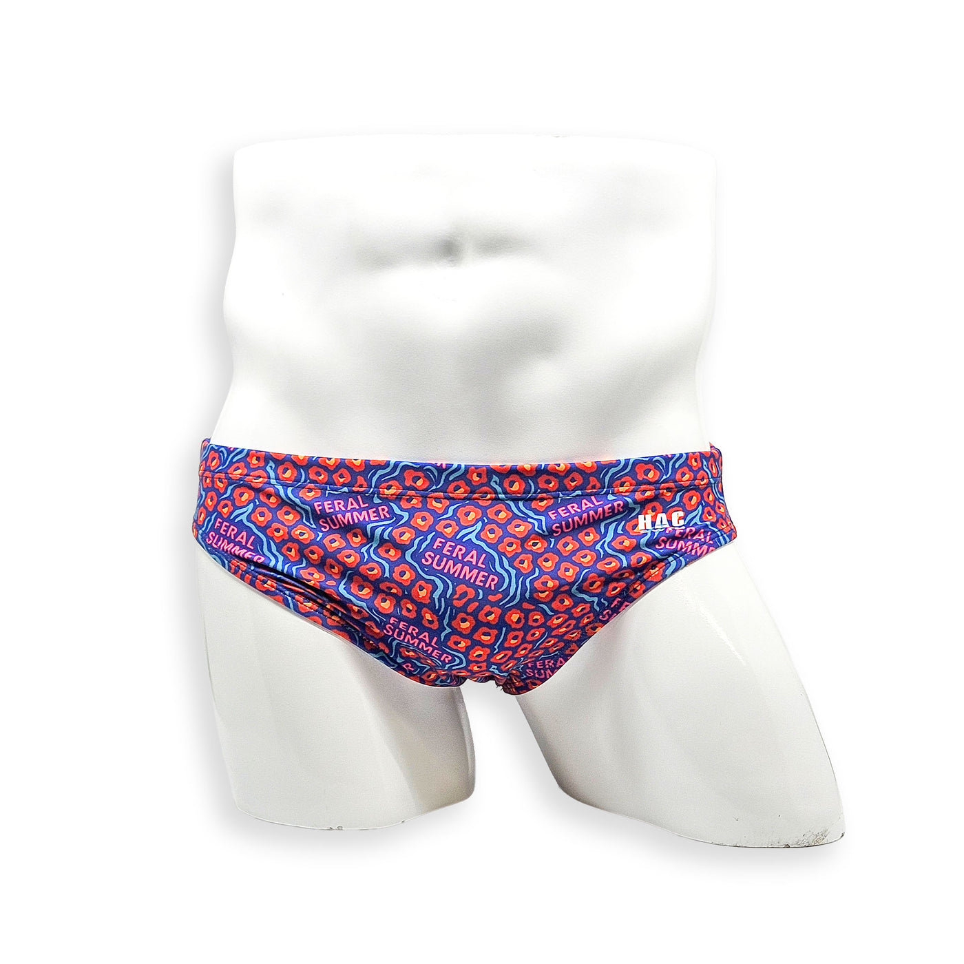 Front view of men’s Flat Front swim brief in HAC Swim’s Feral Summer print featuring electric blue, hot pink lettering and orange abstract pattern.