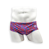 Front view of HAC Swim Vintage Swim Brief in the Feral Summer print featuring electric blue, hot pink lettering and orange abstract pattern.