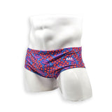 Hero view of HAC Swim Vintage Swim Brief in the Feral Summer print featuring electric blue, hot pink lettering and orange abstract pattern.