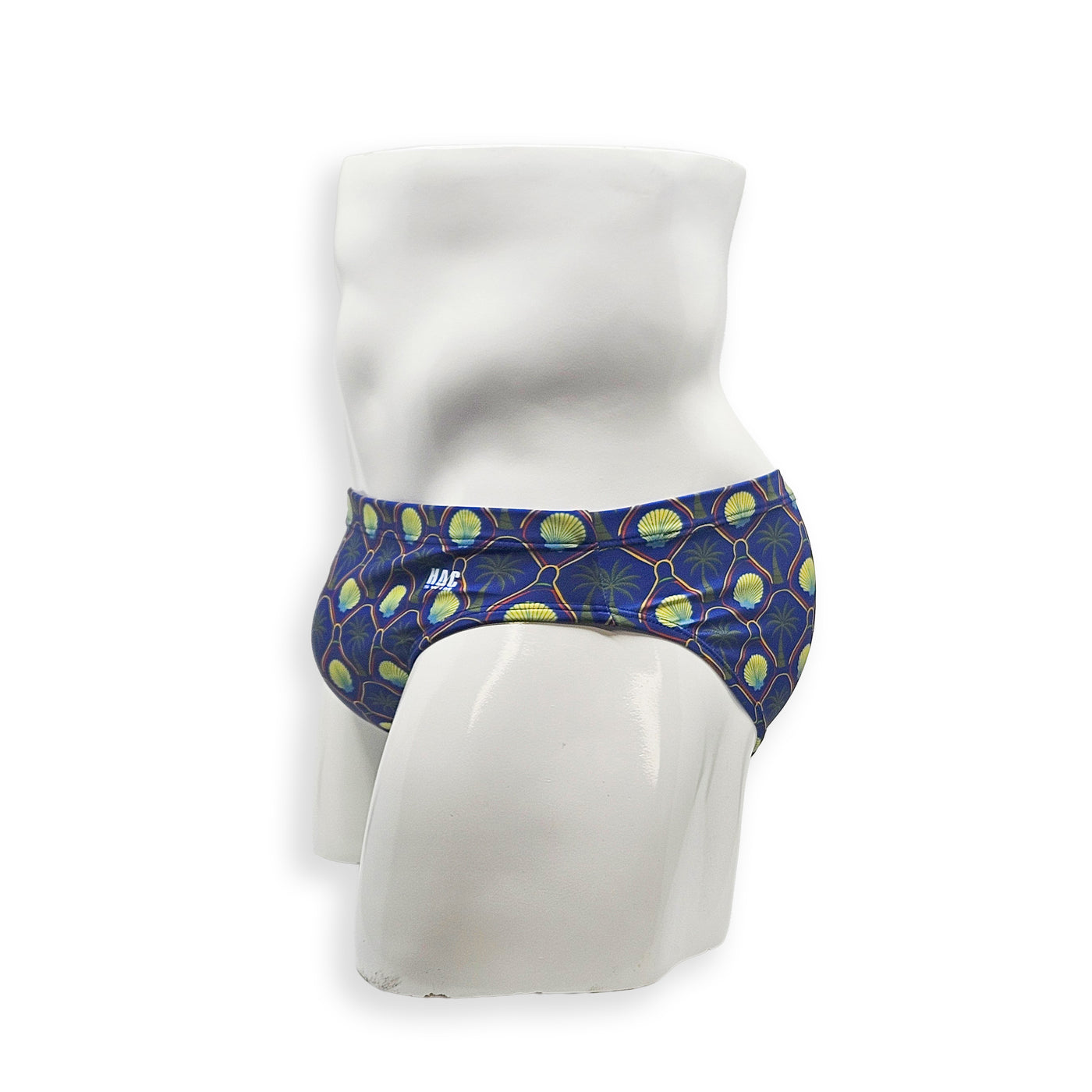 Men’s palm and shell print swim brief – Flat front side view showing low-rise fit and clean silhouette
